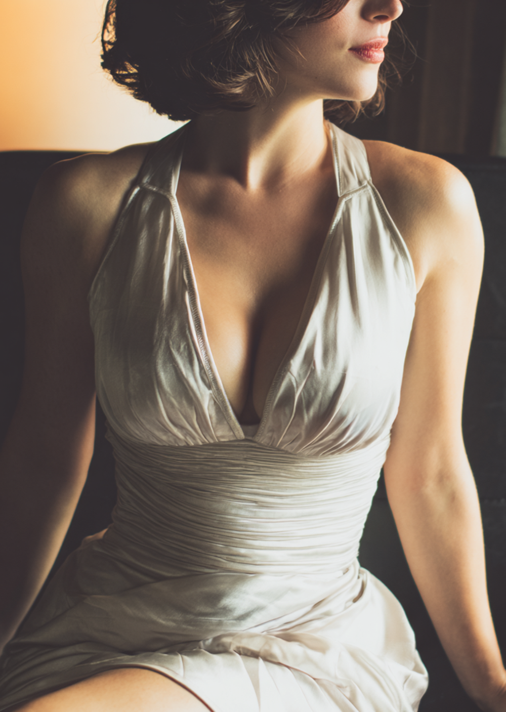 Stunning mature woman in silk cocktail dress, elegant bob hairstyle, cinematic lighting in luxury hotel room, intimate gaze, high-resolution AI photography, sophisticated eroticism.